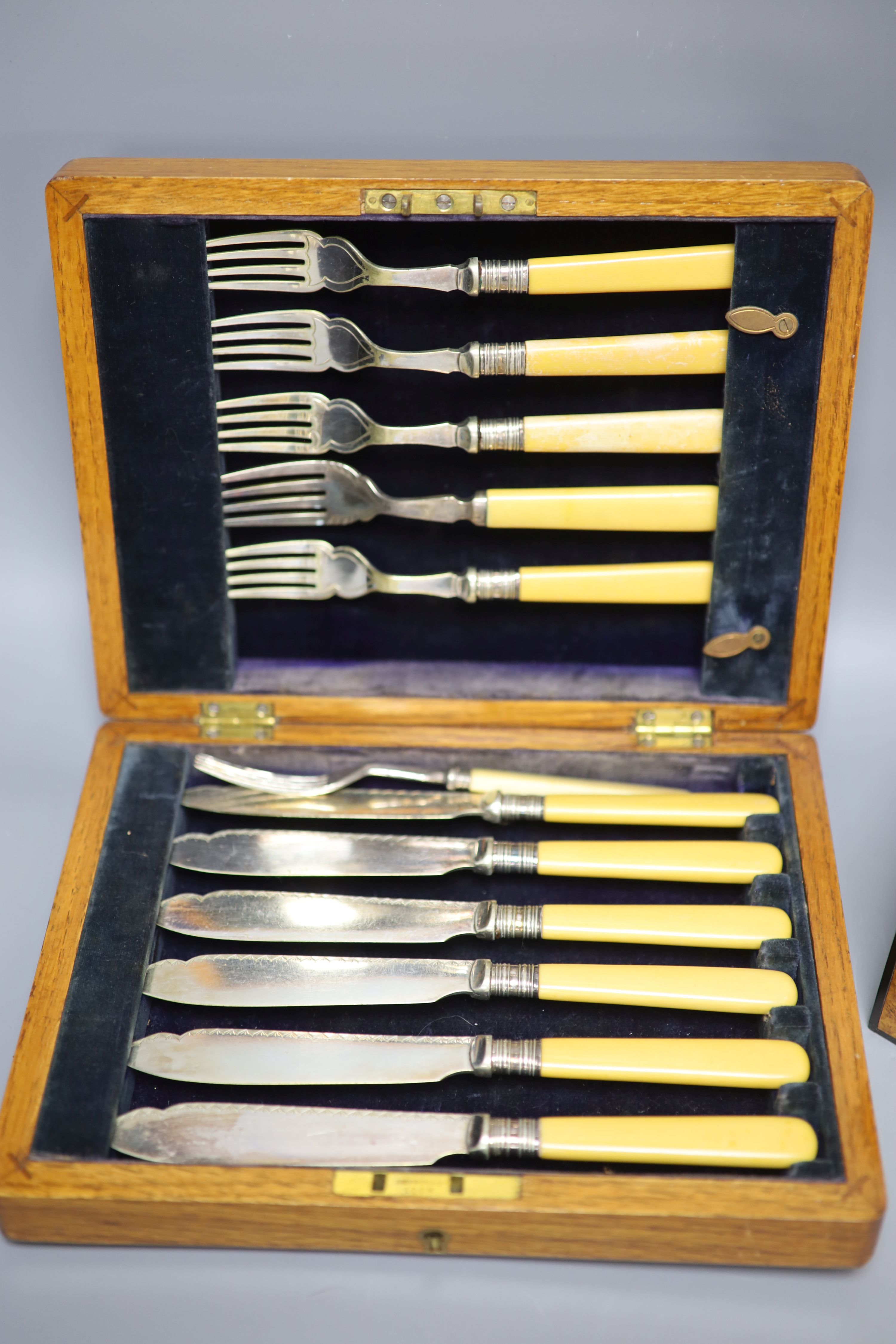 Four cased plated sets and a walnut box